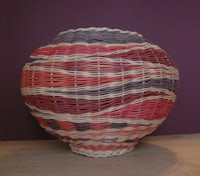 a wicker vase on a table
