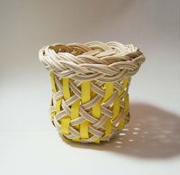 a wicker basket with a yellow ribbon on it